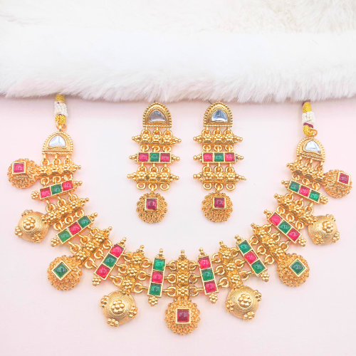 Set of gold jewelry with colorful gemstones on a white background
