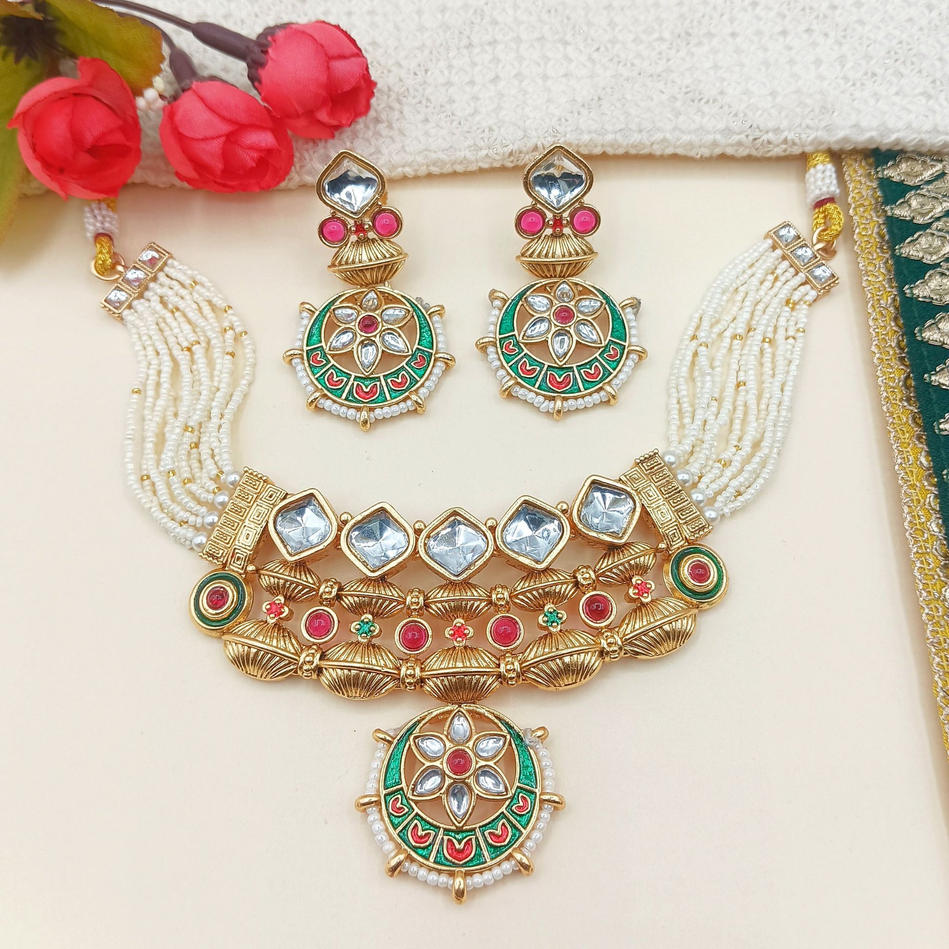 Ornate necklace with matching earrings on a light background