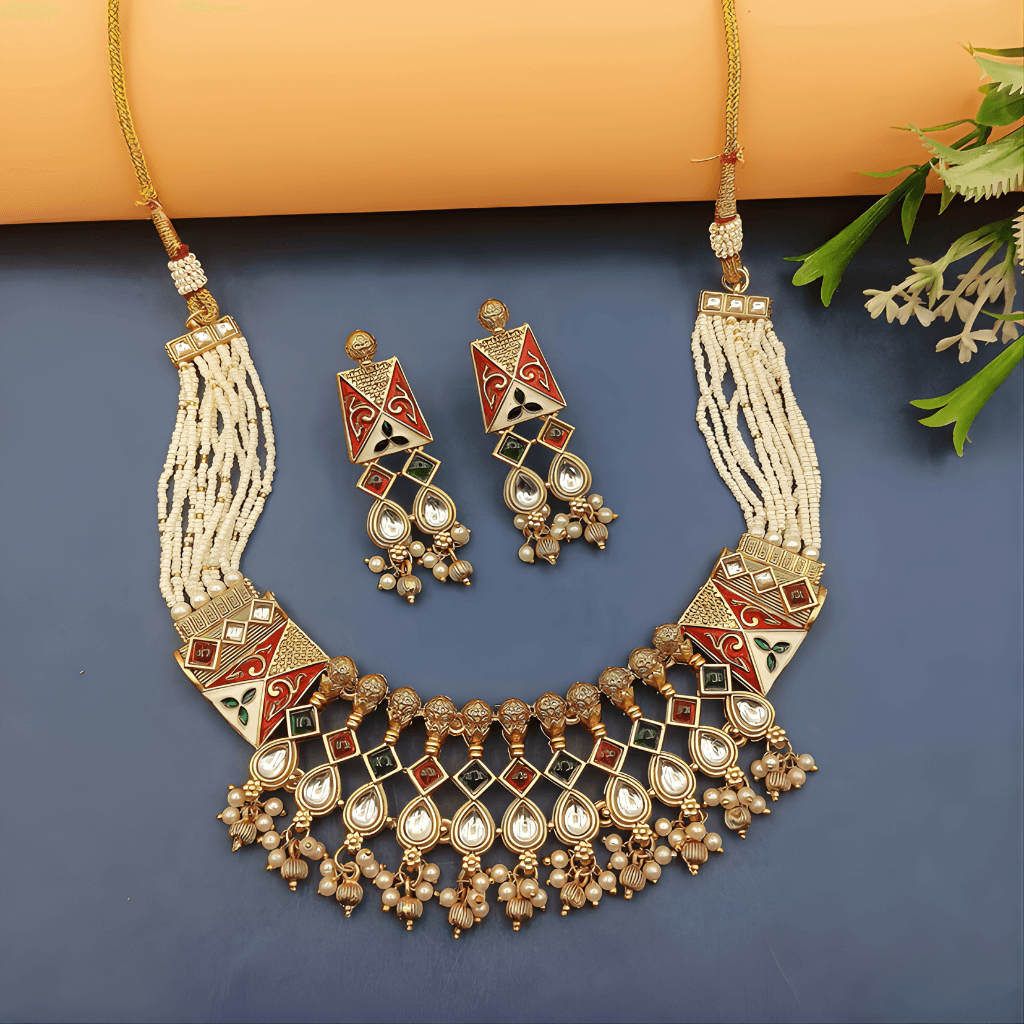 Ornate necklace and earrings set on a blue background