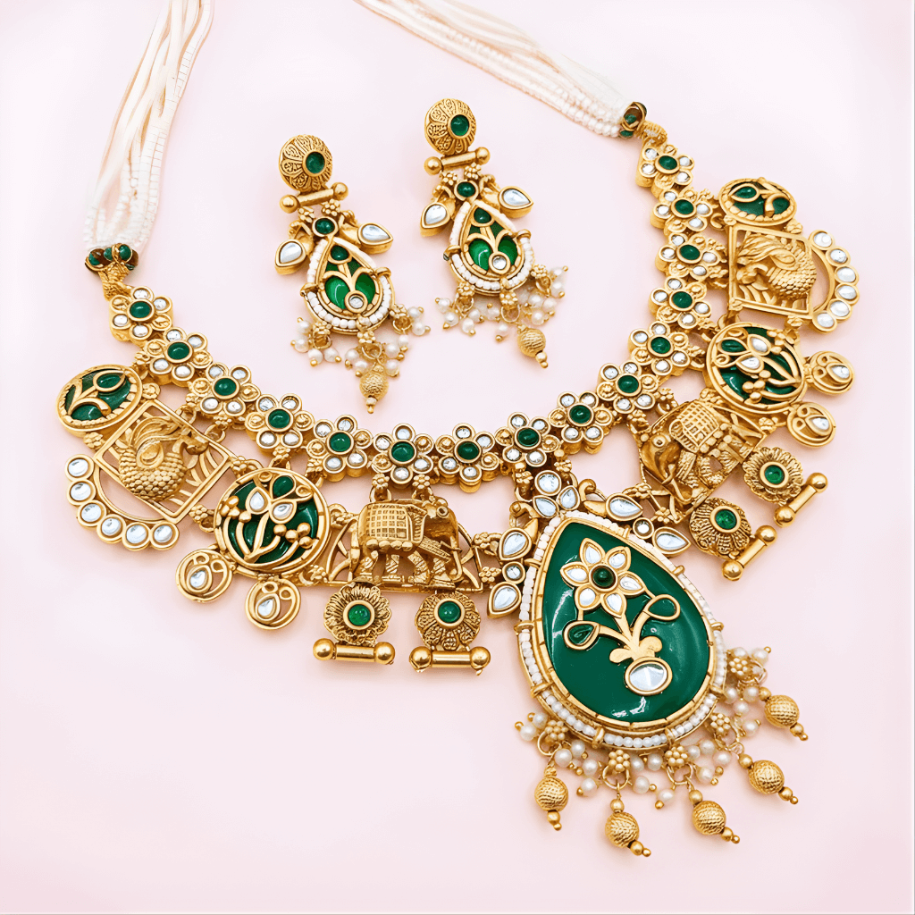 Ornate gold and green jewelry set on a light pink background