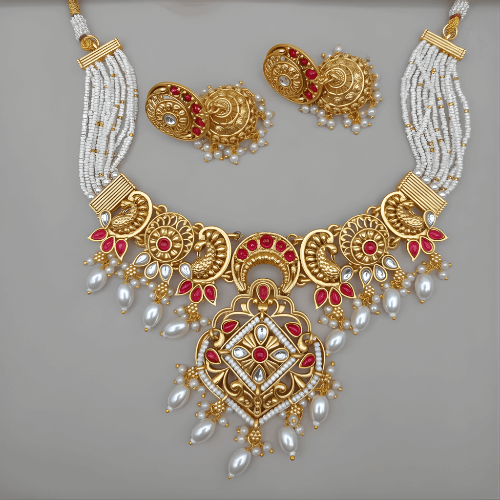 Gold necklace with red and white accents on a gray background