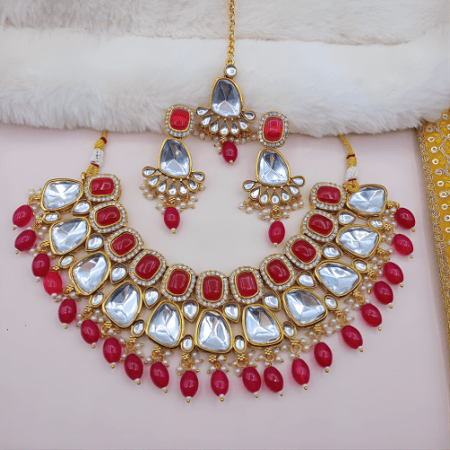 Ornate necklace set with red and white stones on a soft background