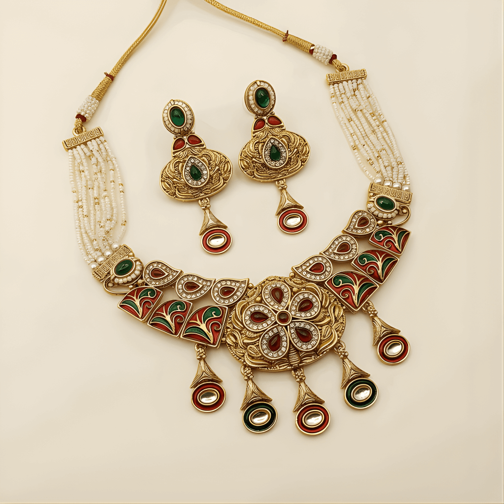 Ornate gold necklace with red and green gemstones on a beige background