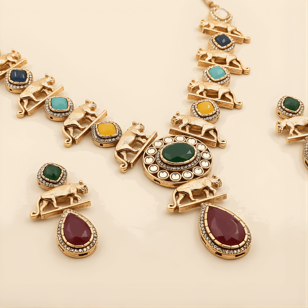 Gold jewelry set with colorful gemstones on a beige background