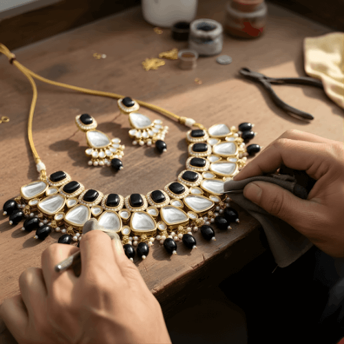 Jewelry making process with a necklace and earrings on a wooden surface.