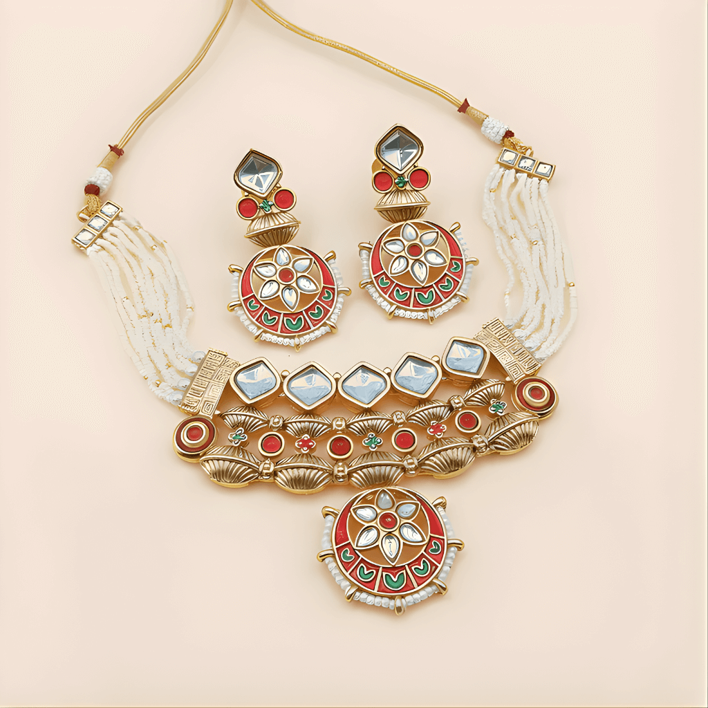 Ornate gold necklace with red, green, and white stones on a beige background