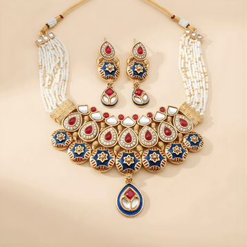 A gold and pearl necklace with matching earrings, featuring red, white, and blue enamel designs. The set exudes elegance and luxury against a soft background.