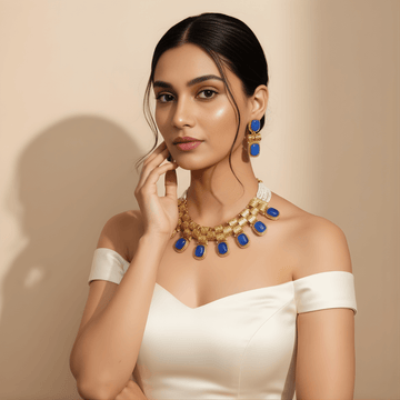 Woman wearing a gold and blue necklace with a beige background