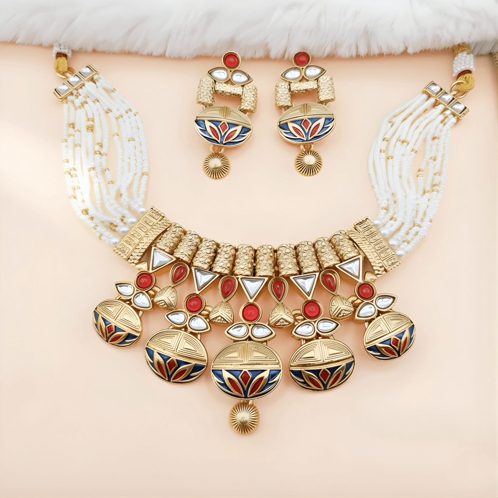 A gold and pearl necklace with matching earrings, featuring red, white, and blue enamel designs. The set exudes elegance and luxury against a soft background.