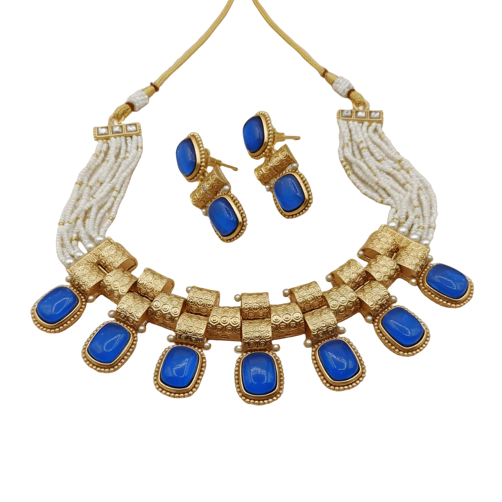 Jewelry set with gold necklace and earrings featuring blue stones on a beige background
