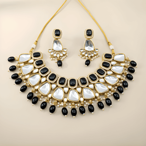 Ornate necklace with black and white stones on a beige background