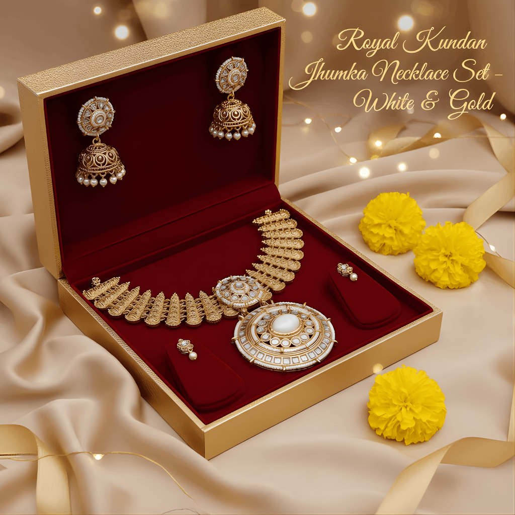 Gold necklace set with earrings in a jewelry box on a satin surface with yellow flowers.