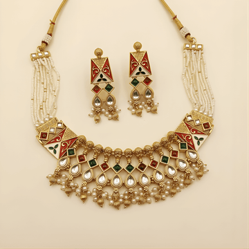 Ornate necklace and earrings set on a beige background